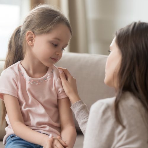 Loving mom talking to upset little child girl giving support Loving worried mom psychologist consoling counseling talking to upset little child girl showing care give love support, single parent mother comforting sad small sullen kid daughter feeling offended